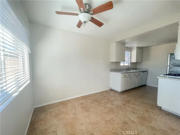 a kitchen with stainless steel appliances white cabinets and a stove top oven