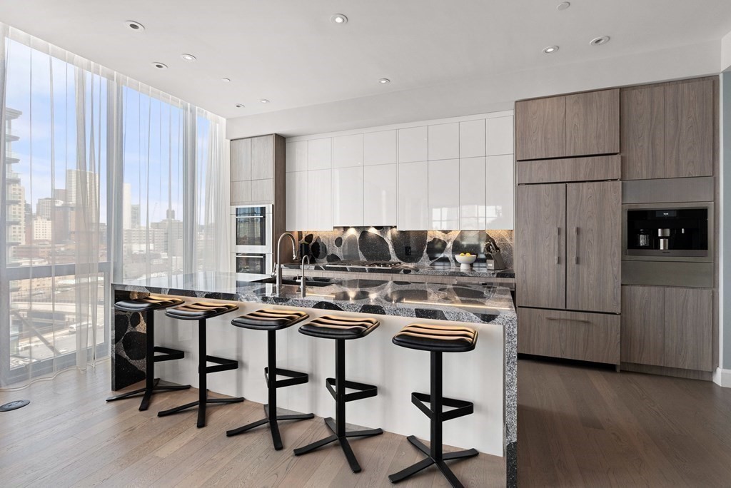 140 Shawmut Avenue, Unit 8A Boston, MA 02118 - Photo 13 of 29 a kitchen with a table chairs refrigerator and cabinets