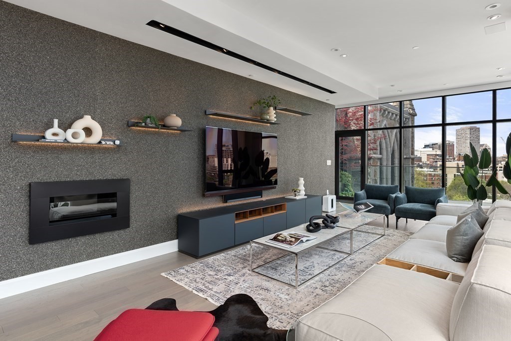 140 Shawmut Avenue, Unit 8A Boston, MA 02118 - Photo 2 of 29 a living room with furniture fireplace and flat screen tv