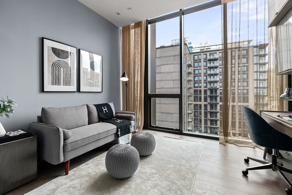 140 Shawmut Avenue, Unit 8A Boston, MA 02118 - Photo 22 of 29 a living room with furniture and a floor to ceiling window