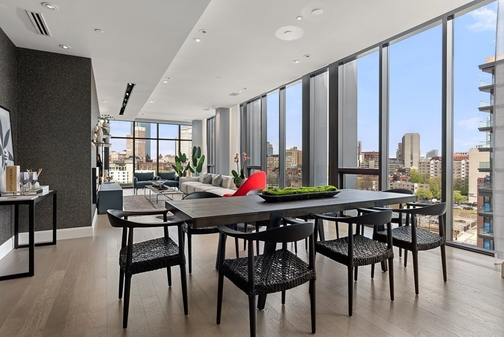 140 Shawmut Avenue, Unit 8A Boston, MA 02118 - Photo 8 of 29 a view of a dining room and livingroom with furniture wooden floor a rug a painting and a chandelier