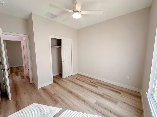 wooden floor in an empty room with a window