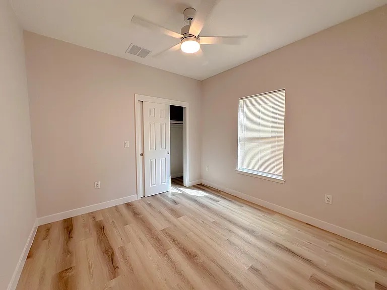 817 5th Street Lockhart, TX 78644 - Photo 15 of 18 an empty room with windows and fan