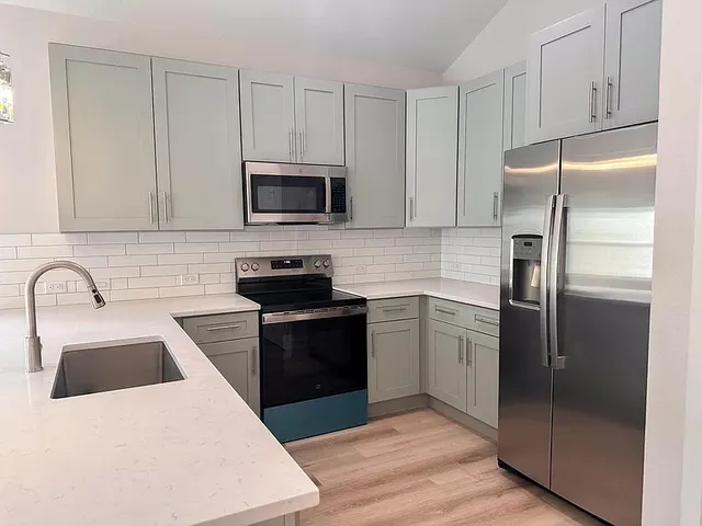 a kitchen with a refrigerator sink and microwave