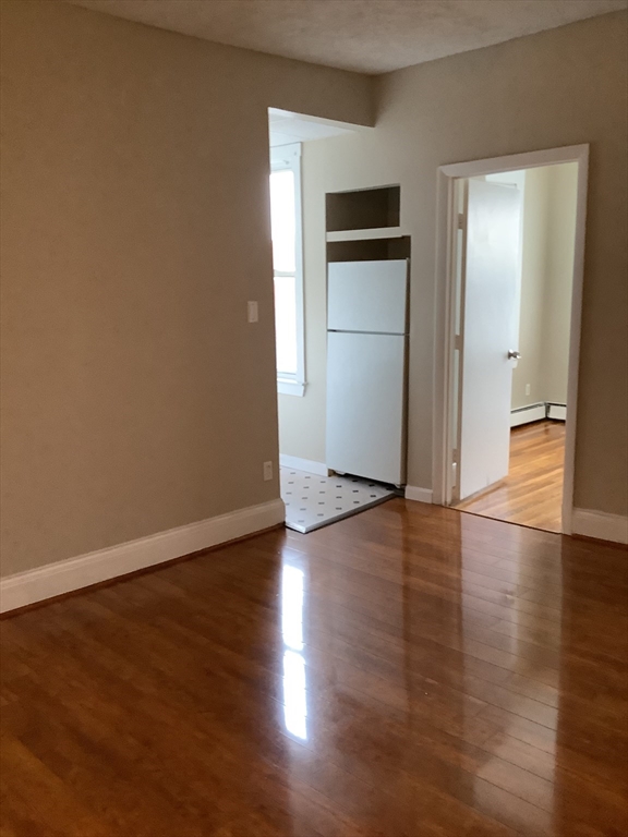 61 Vine Street, Unit 35 Lynn, MA 01905 - Photo 11 of 11 an empty room with wooden floor and closet