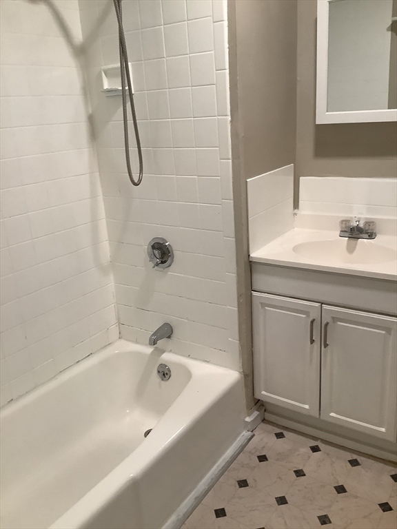 61 Vine Street, Unit 35 Lynn, MA 01905 - Photo 5 of 11 a bathroom with a sink a toilet and shower