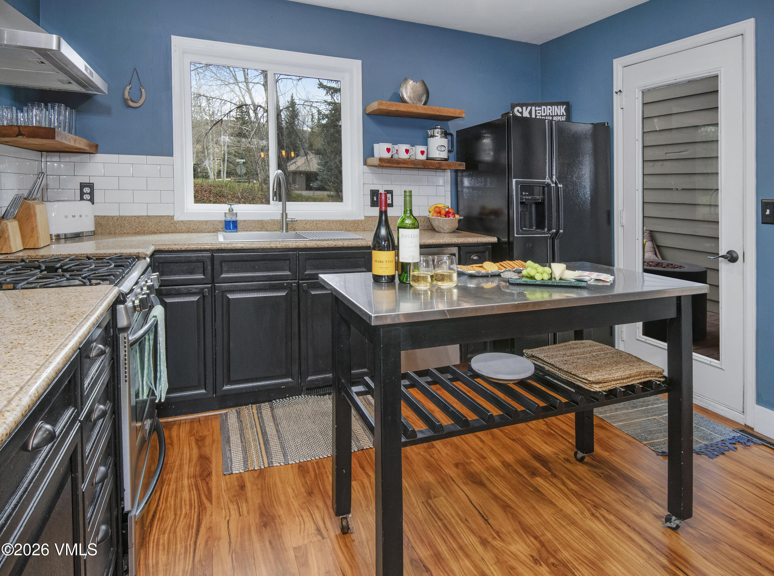 83 Arlington Place, Unit A2 Edwards, CO 81632 - Photo 6 of 19 a kitchen with stainless steel appliances granite countertop a stove top oven a sink dishwasher and cabinets with wooden floor