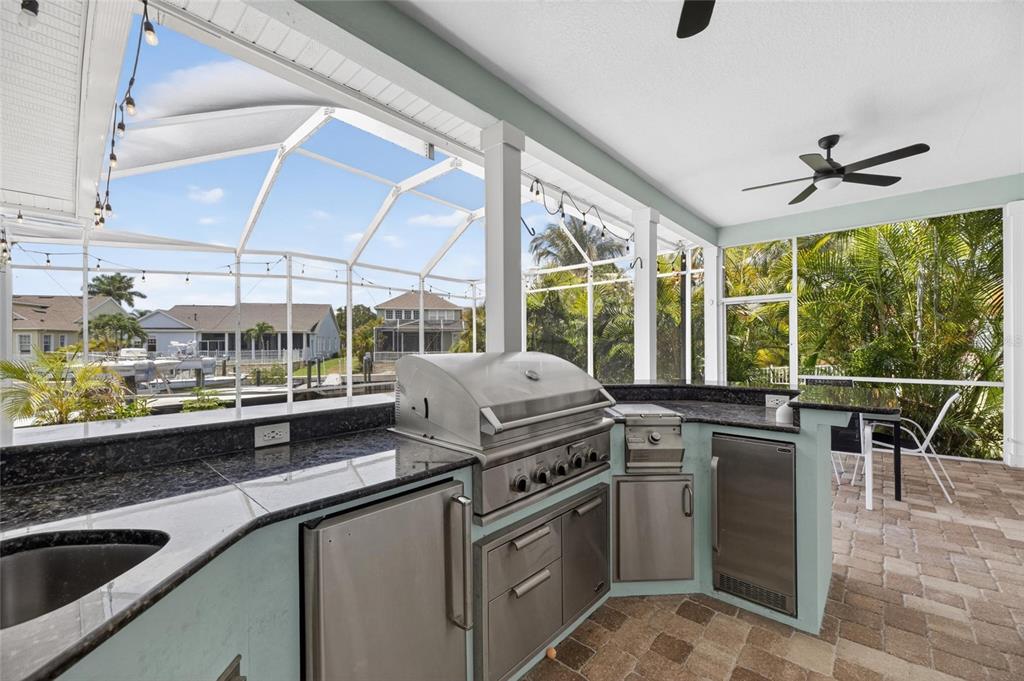508 Islebay Drive Apollo Beach, FL 33572 - Photo 83 of 98 a kitchen with stainless steel appliances granite countertop a sink a stove and a cabinets