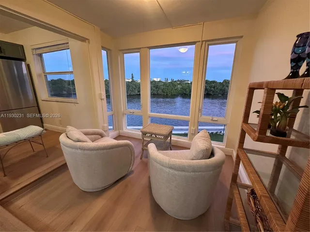 a living room with furniture and a floor to ceiling window