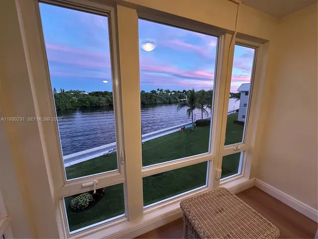 a view of a balcony with a floor to ceiling window next to a yard
