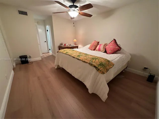 a bedroom with a bed and a ceiling fan