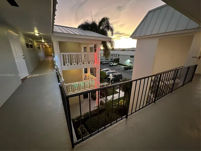 a front view of a building with a garden