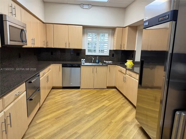 a living room with lots of furniture a dining table and chairs