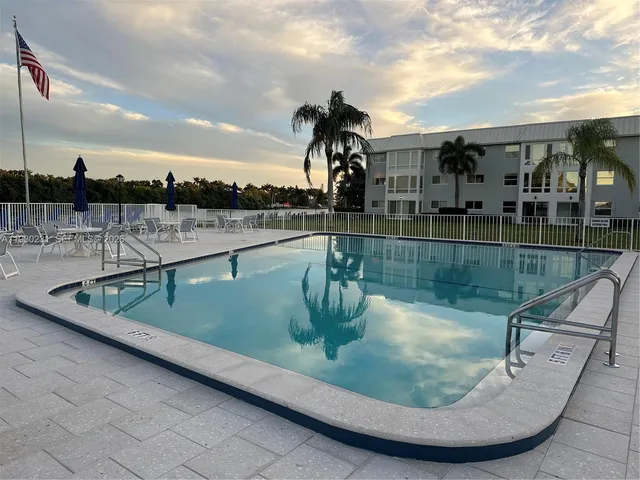 a view of a swimming pool with a table and chairs