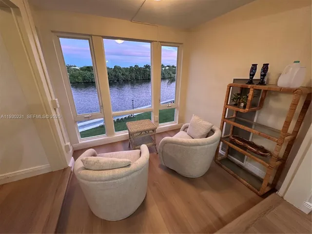 a living room with furniture and a floor to ceiling window