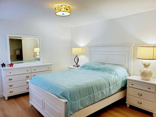 a bedroom with a bed and a dresser