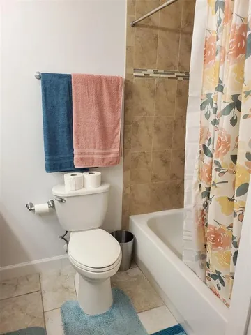 a bathroom with a toilet and a bathtub