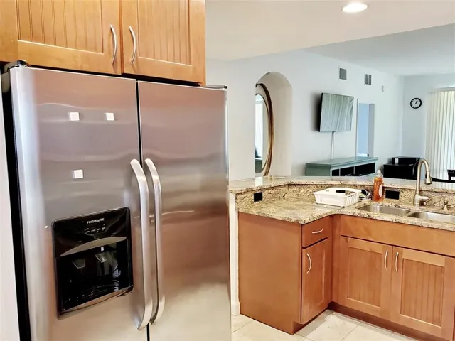 a kitchen with a sink appliances and cabinets