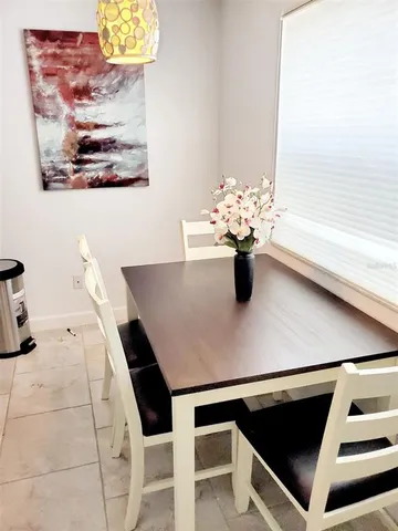 a kitchen with a table and chairs