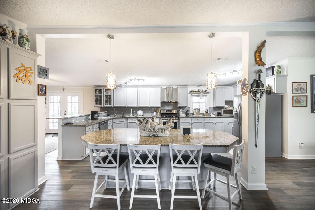 319 Pope Road Roberta, GA 31078 - Photo 11 of 42 a kitchen with a dining table chairs and refrigerator