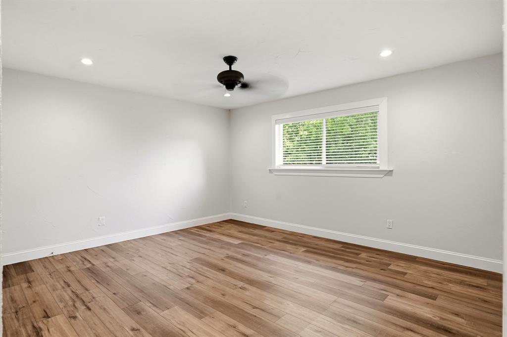 7354 Walling Lane Dallas, TX 75231 - Photo 22 of 28 a view of an empty room with wooden floor and a window