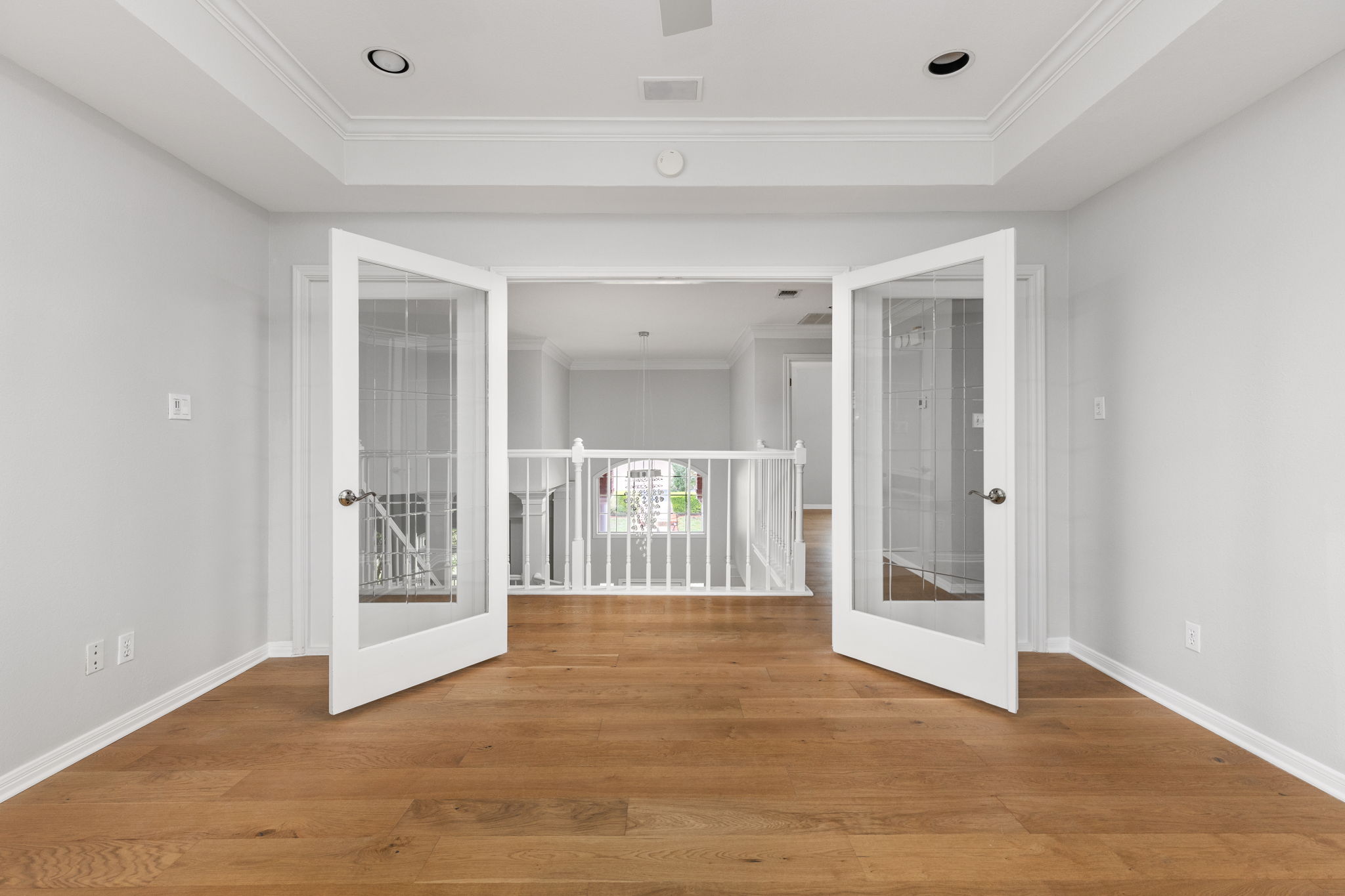 2807 Round Table Road Austin, TX 78746 - Photo 20 of 40 Office/Den emptyfeaturing double glass-paneled doors opening to a white baluster railing