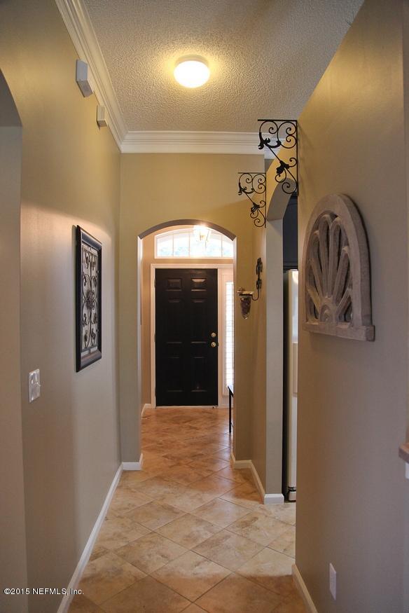 4308 Rye Court St. Johns, FL 32259 - Photo 5 of 18 a view of a hallway with a white door and a wooden floor