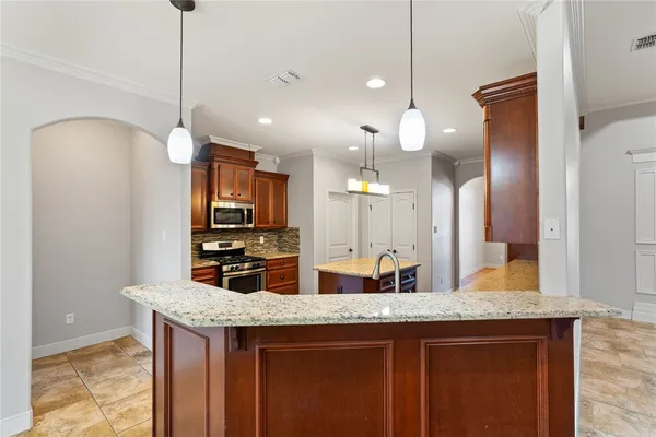 a kitchen with center island and stainless steel appliances