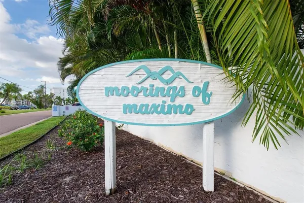 a view of a wooden fence with a tree in the background