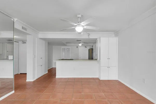 a view of an empty room with a ceiling fan