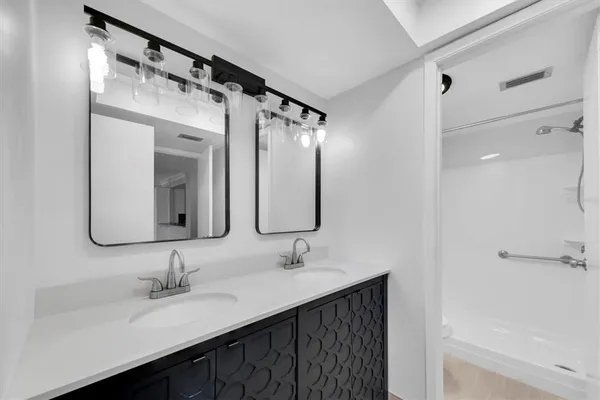 a bathroom with a double vanity sink mirror and double