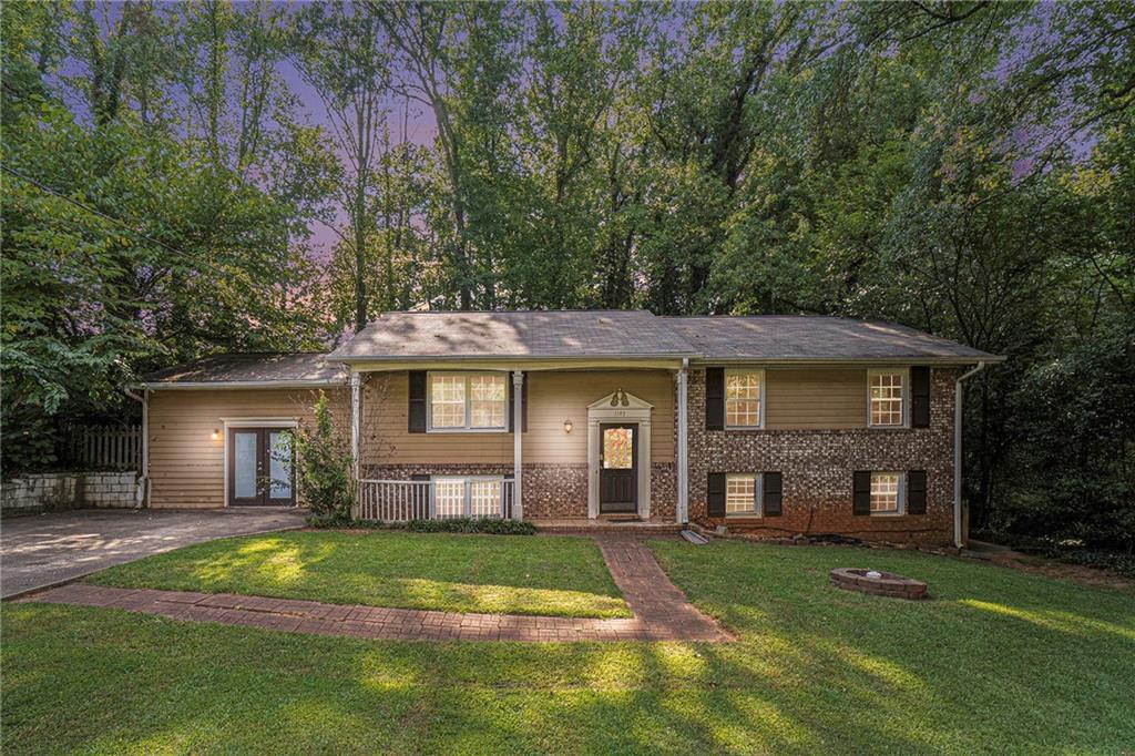 1145 Woodleigh Road Southwest Marietta, GA 30008 - Photo 1 of 1 a front view of a house with a yard