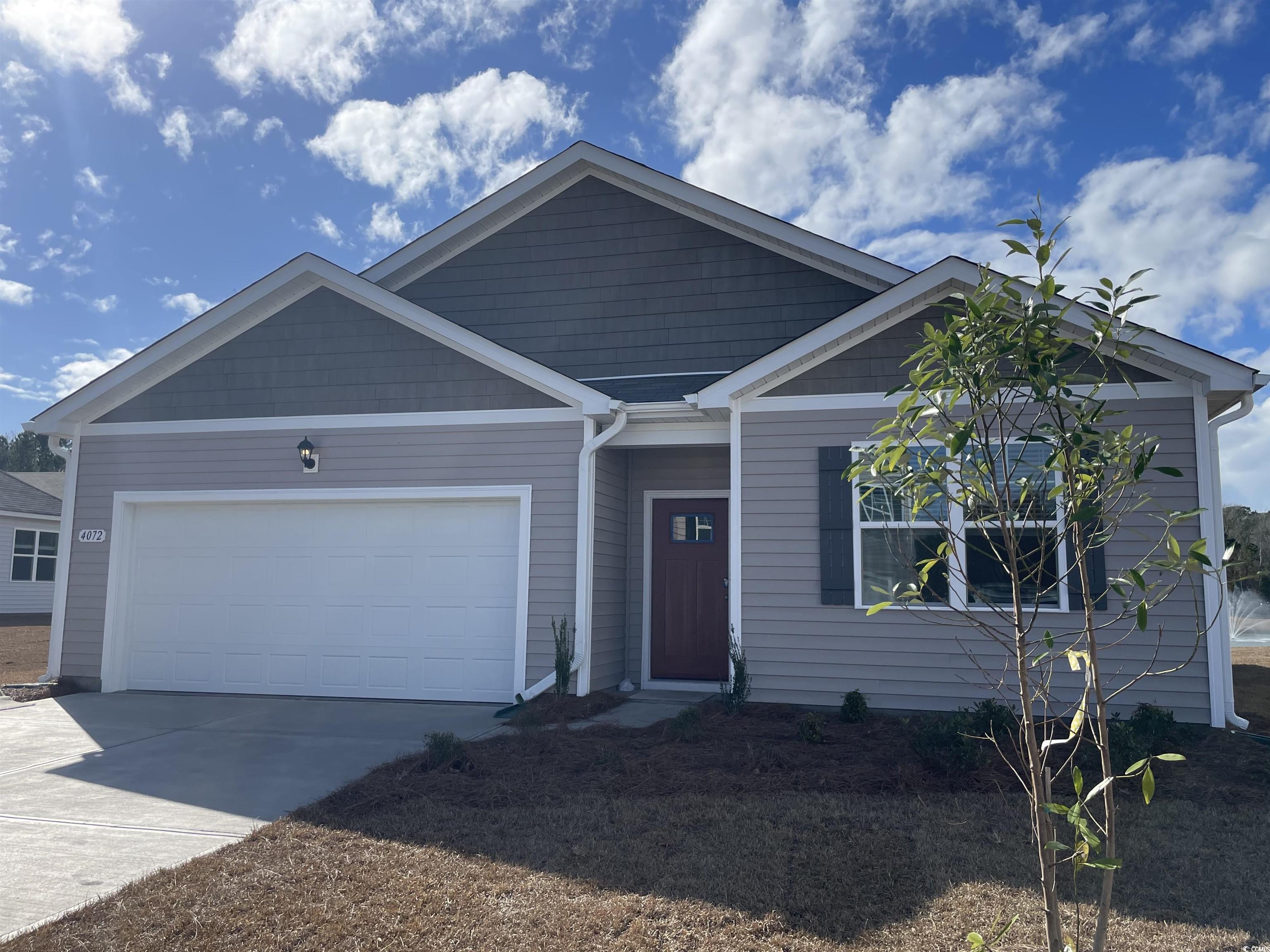 View of front facade featuring a garage