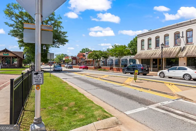 a sign board with buildings in the background