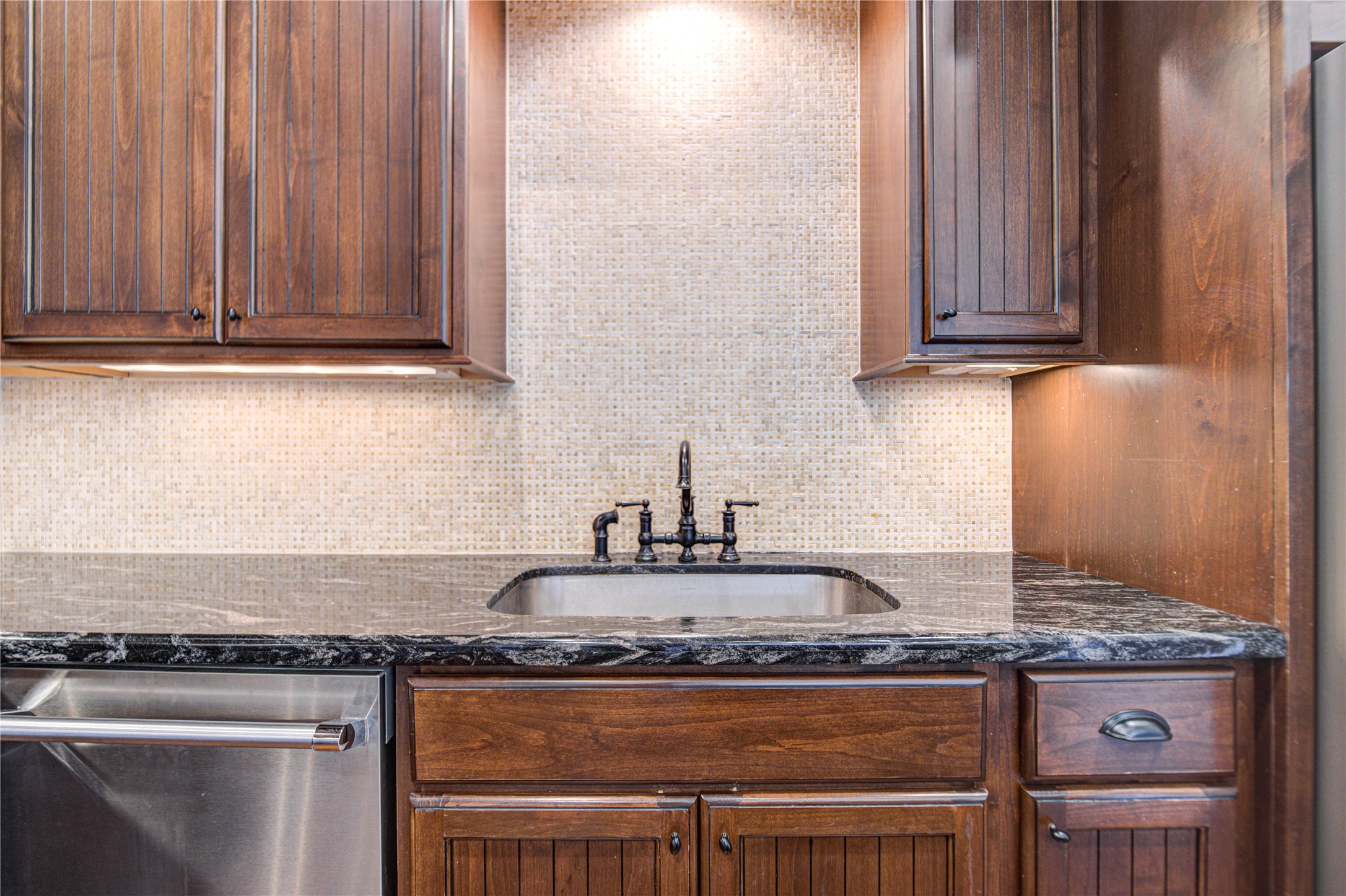 6520 Rodrigo Street Houston, TX 77007 - Photo 7 of 44 Kitchen sink area featuring granite countertops, custom cabinetry, designer backsplash, and under-cabinet lighting.