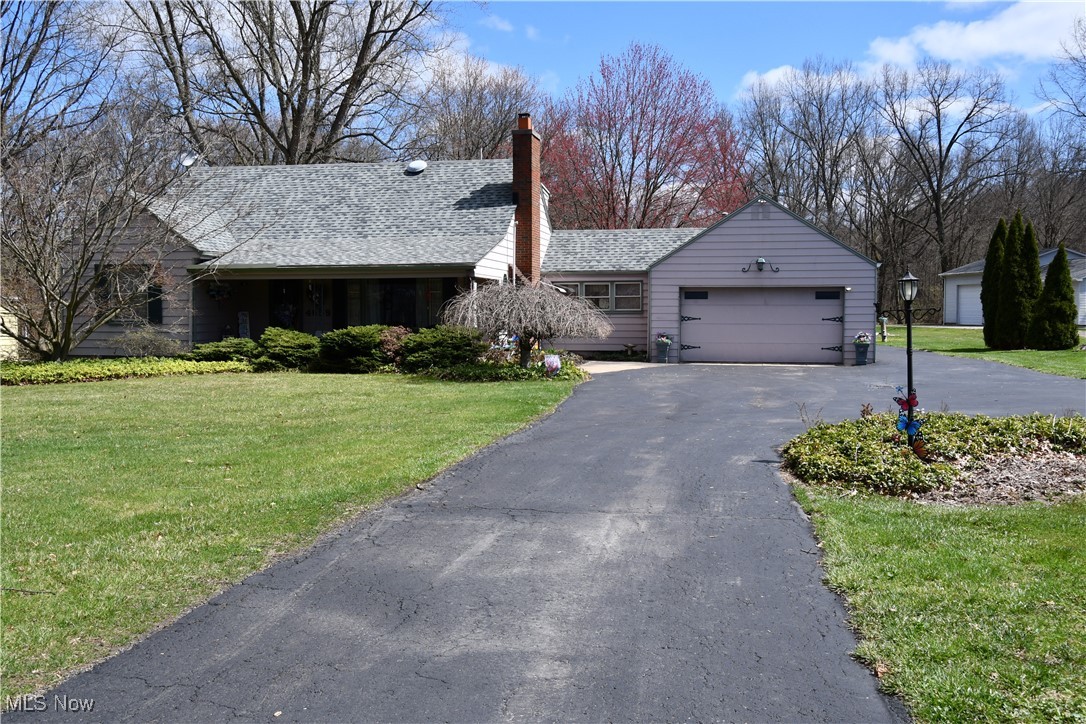 4659 Canfield Road Canfield, OH 44406 - Photo 1 of 34 Single story home featuring a garage, a front yard, aphalt driveway, and a chimney