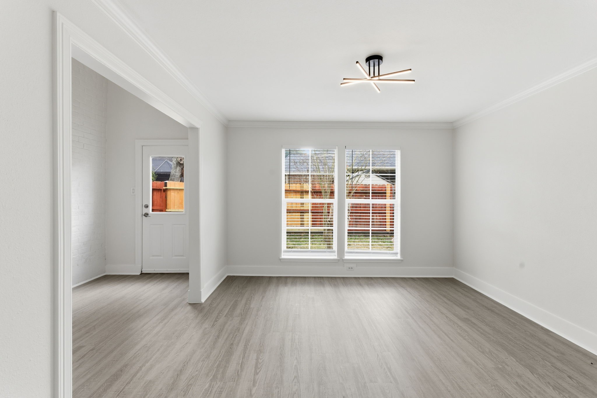 13811 Menasco Court Houston, TX 77077 - Photo 11 of 50 The formal dining room has an updated light fixture, crown molding and views of the backyard.