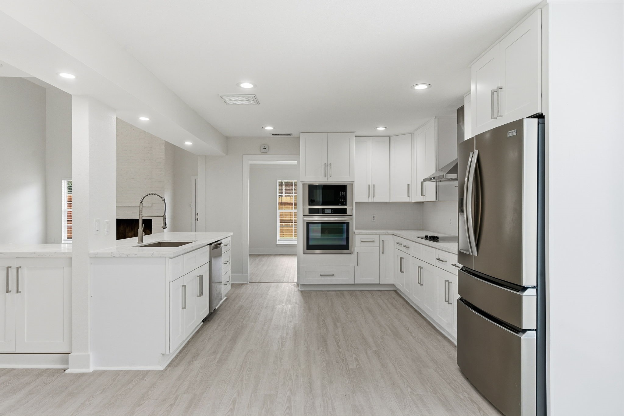13811 Menasco Court Houston, TX 77077 - Photo 15 of 50 This beautiful kitchen has been remodeled with top tier appliances, LED recessed lighting, quartz counters, tile backsplash and shaker style cabinetry.