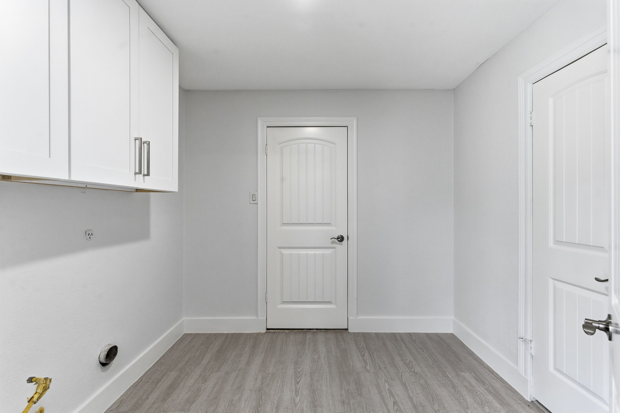 13811 Menasco Court Houston, TX 77077 - Photo 23 of 50 The utility room accommodates a full size washer and dryer. The half bathroom can be accessed from the door on the right.