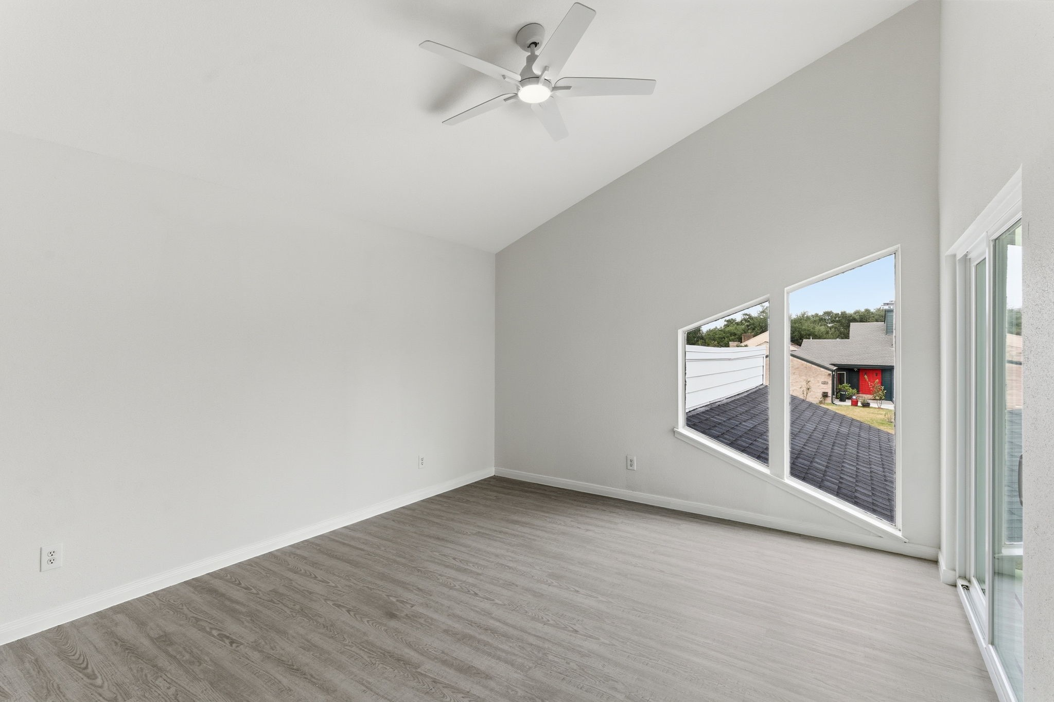 13811 Menasco Court Houston, TX 77077 - Photo 34 of 50 Bedroom #2 is located upstairs with luxury vinyl plank floors, high ceilings, a ceiling fan, nice size closet and double pane sliding glass door that opens to the front balcony.