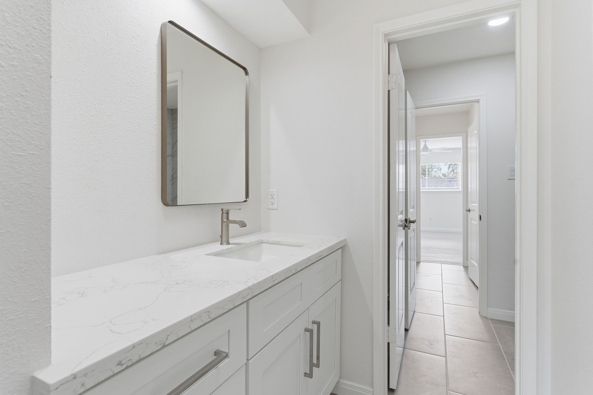 13811 Menasco Court Houston, TX 77077 - Photo 35 of 50 The full bath rooms upstairs is Jack and Jill style. There are quartz counters, double sinks and tile floors.