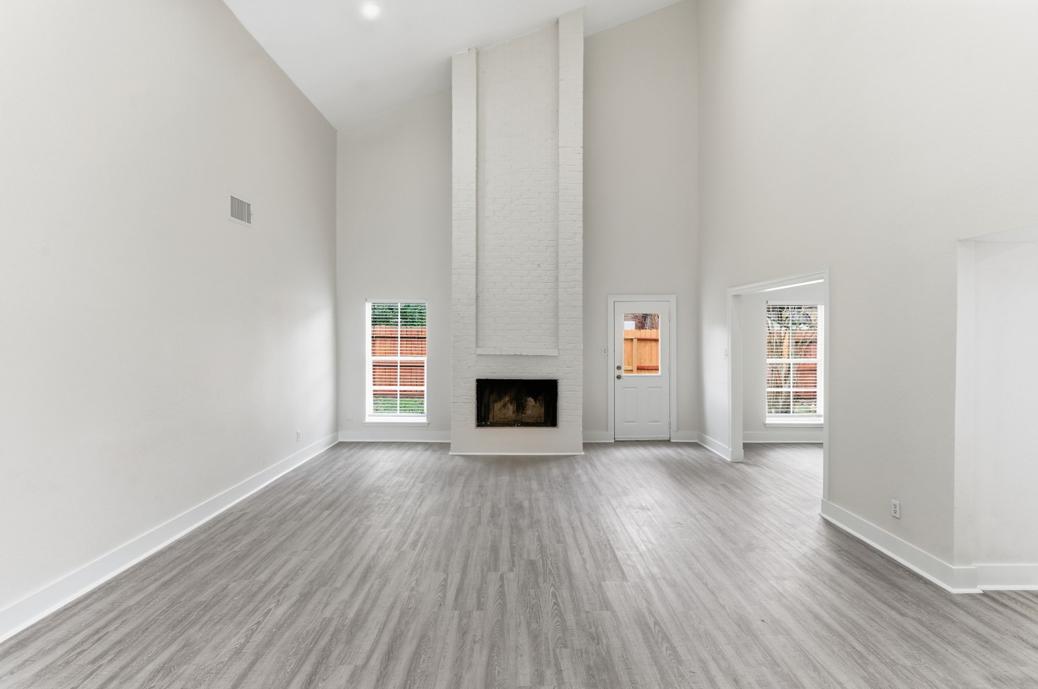 13811 Menasco Court Houston, TX 77077 - Photo 5 of 50 The spacious family room features vaulted ceilings, wood burning fireplace, LED recessed lighting and an oversized updated ceiling fan. You can access the backyard through the single door on the right.
