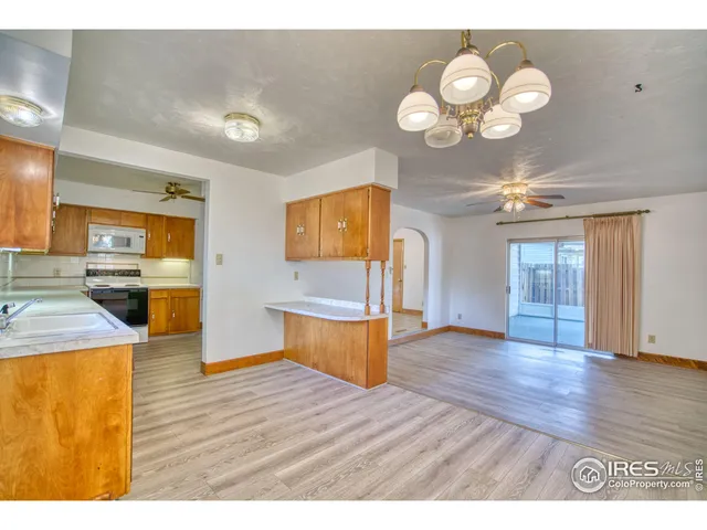 a view of a kitchen with wooden floor