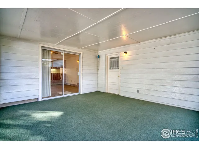 a view of an empty room with a floor to ceiling window