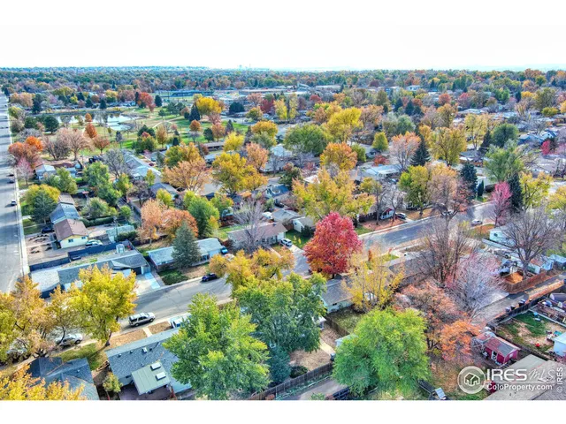 an aerial view of residential houses with outdoor space and swimming pool