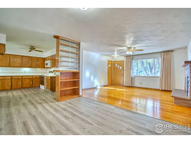 a view of a room with wooden floor and window