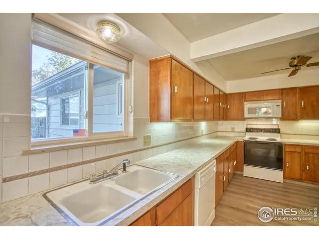 a kitchen with a sink cabinets and appliances