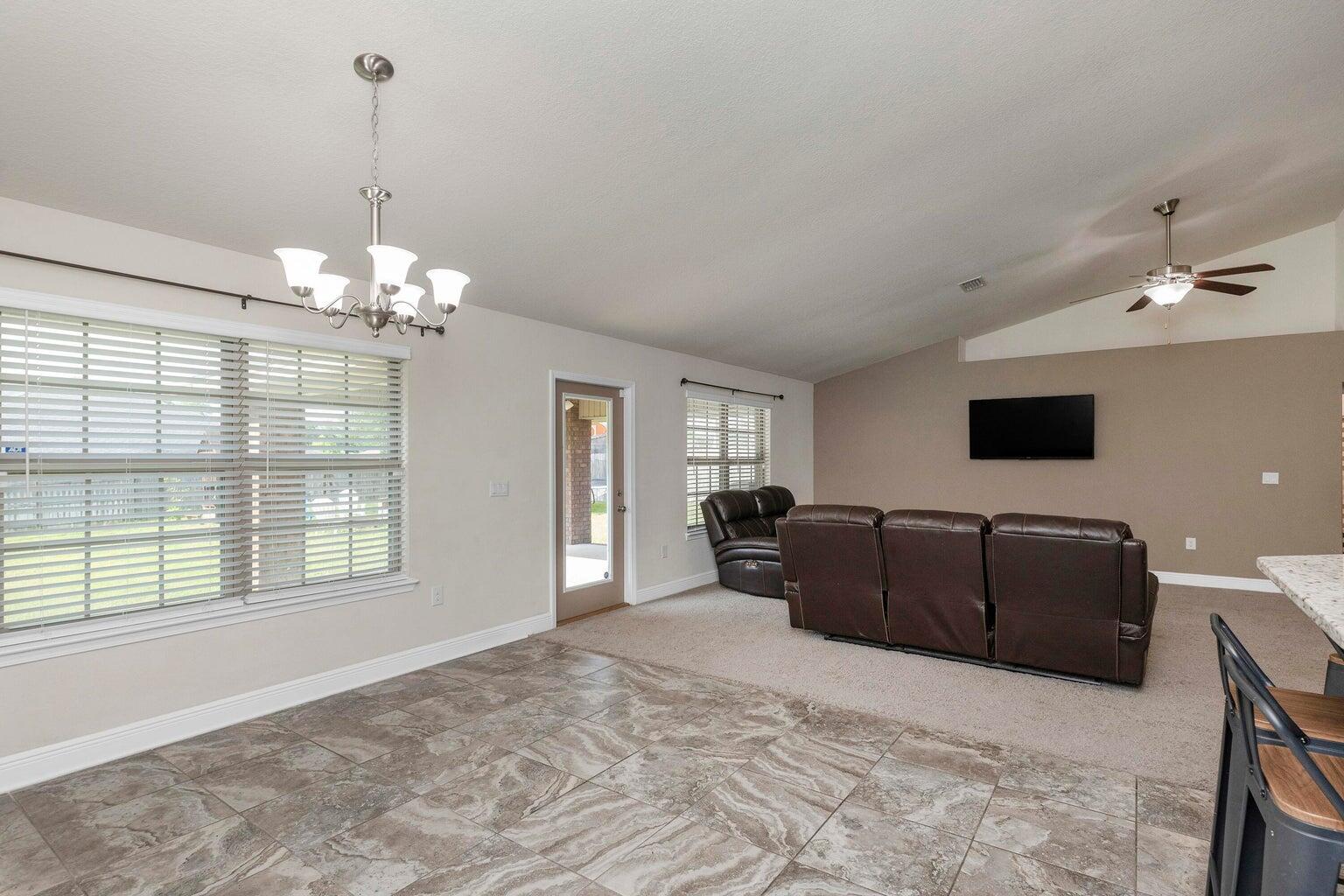 2365 Genevieve Way Crestview, FL 32536 - Photo 13 of 33 a living room with furniture and a chandelier
