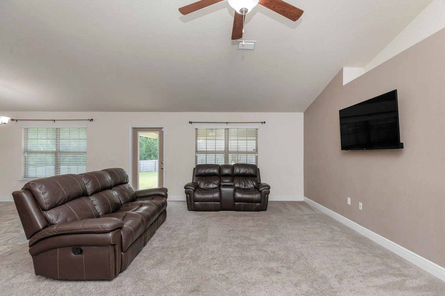 2365 Genevieve Way Crestview, FL 32536 - Photo 15 of 33 a living room with furniture and a flat screen tv