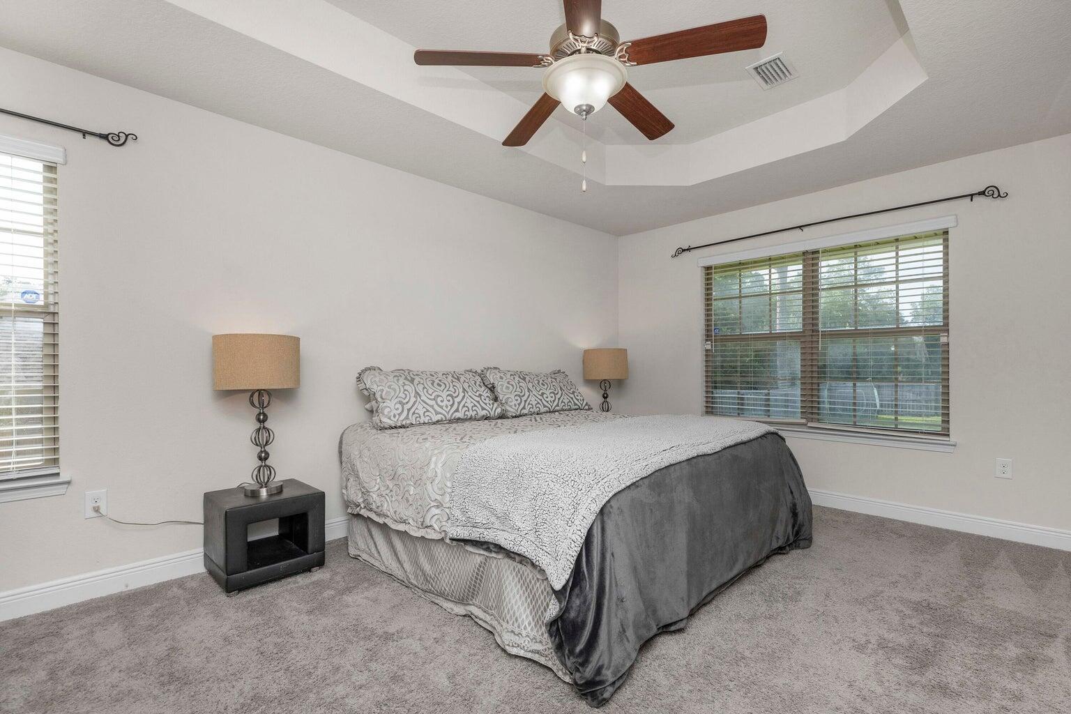 2365 Genevieve Way Crestview, FL 32536 - Photo 18 of 33 a bed room with a bed and a chandelier